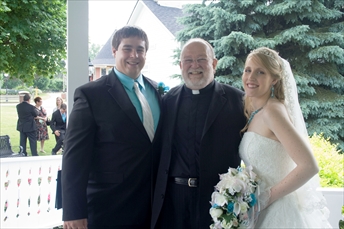 The Reverend with another happy couple.